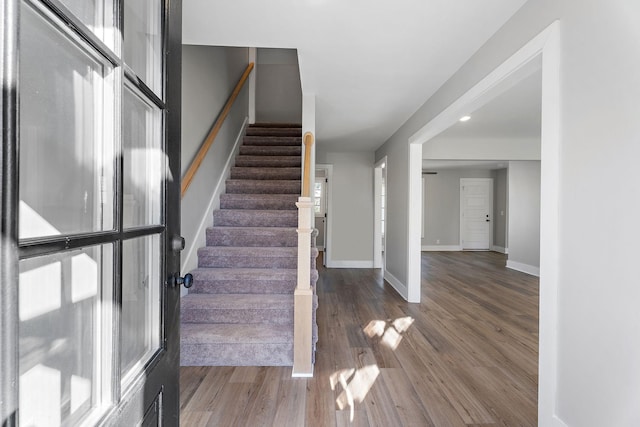 stairway featuring wood-type flooring