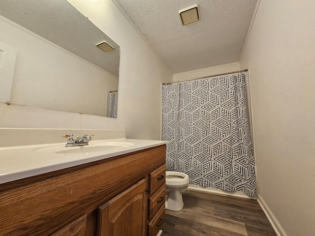 full bathroom with a textured ceiling, toilet, hardwood / wood-style flooring, vanity, and ornamental molding