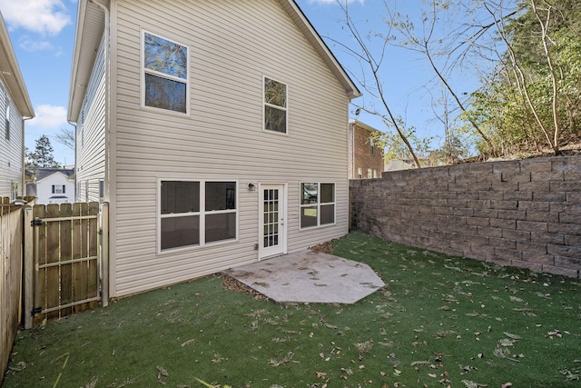 rear view of property with a patio area and a lawn