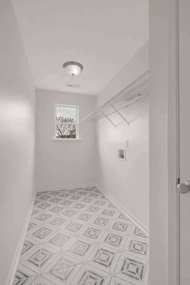 laundry room with laundry area, hookup for a washing machine, visible vents, and baseboards