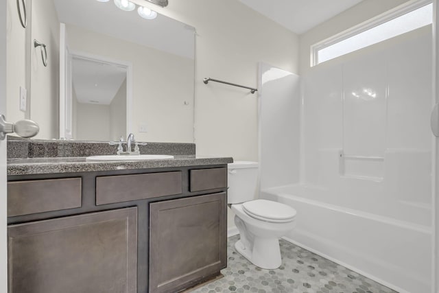 bathroom with toilet, shower / washtub combination, and vanity