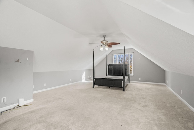 unfurnished room featuring lofted ceiling, ceiling fan, and carpet flooring