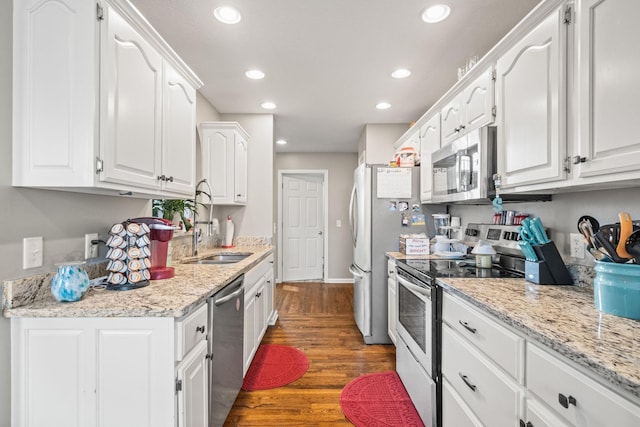 kitchen featuring appliances with stainless steel finishes, white cabinets, and dark wood-style floors