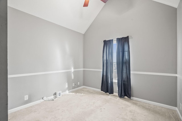 spare room with light carpet, visible vents, baseboards, a ceiling fan, and vaulted ceiling