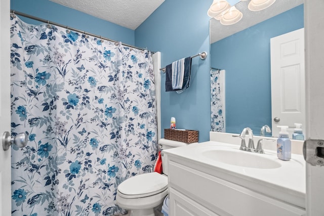 bathroom featuring toilet, a textured ceiling, walk in shower, and vanity