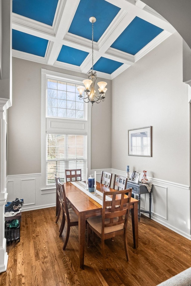 dining space featuring beamed ceiling, a notable chandelier, crown molding, and coffered ceiling