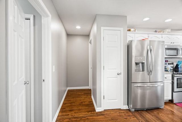 kitchen featuring white cabinetry, baseboards, light countertops, appliances with stainless steel finishes, and dark wood-style floors