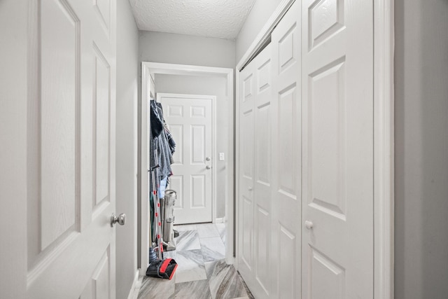 corridor with a textured ceiling