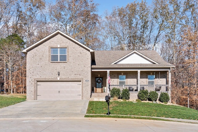 view of front of home featuring covered porch, a garage, and a front lawn