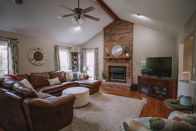 living room with a fireplace, wood-type flooring, plenty of natural light, and beam ceiling