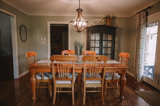 dining room with a notable chandelier, dark hardwood / wood-style floors, and crown molding