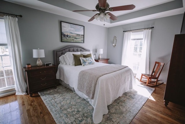 bedroom with ceiling fan and dark hardwood / wood-style flooring