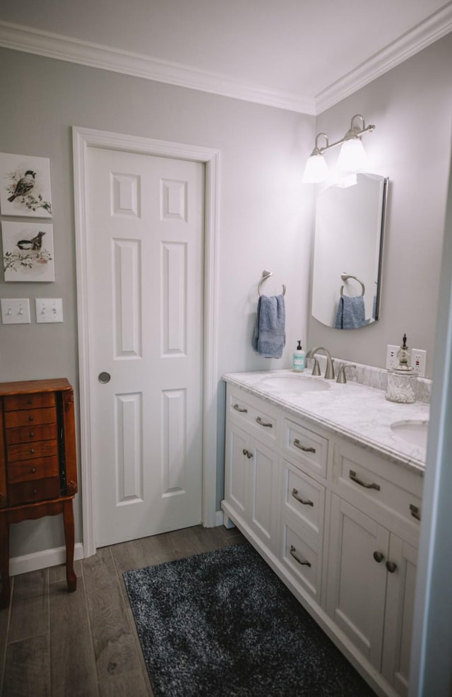 bathroom featuring wood-type flooring, vanity, and crown molding