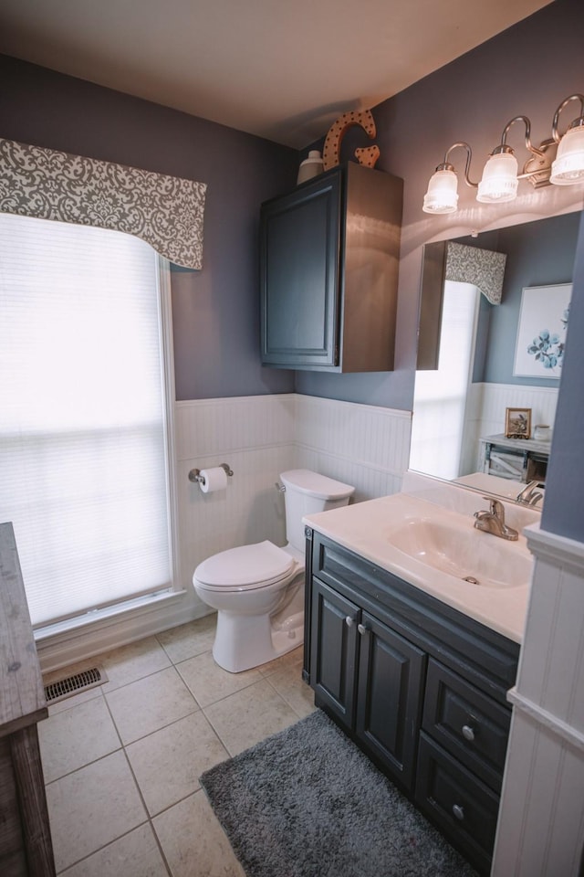 bathroom featuring tile patterned flooring, vanity, and toilet