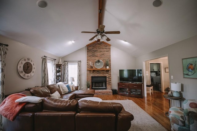 living room featuring a fireplace, hardwood / wood-style floors, ceiling fan, and lofted ceiling