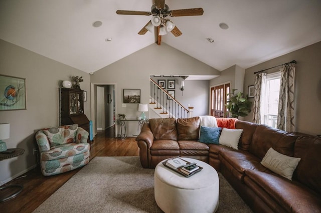 living room with vaulted ceiling with beams, ceiling fan, and dark wood-type flooring