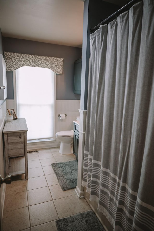 bathroom with tile patterned floors, vanity, and toilet