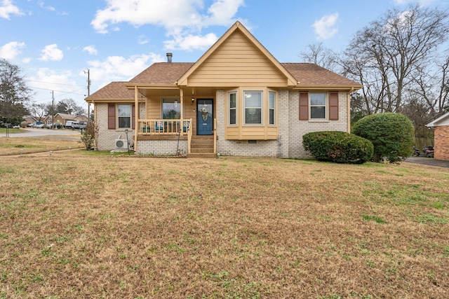 bungalow-style home featuring covered porch and a front lawn