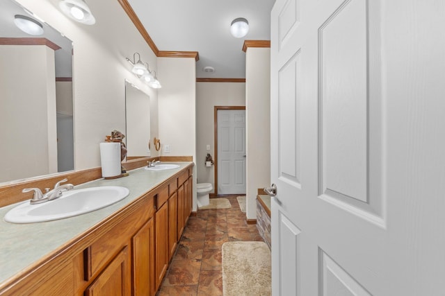 bathroom with crown molding, vanity, and toilet