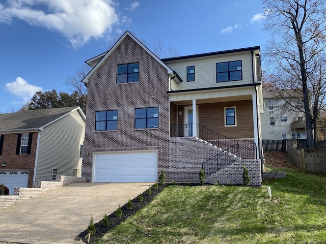 view of front of property with a front yard and a garage