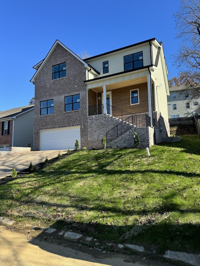 view of front of property featuring a porch, a garage, and a front lawn