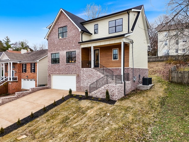 view of front of house with a garage, central AC, brick siding, fence, and driveway