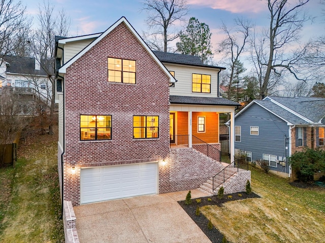 view of front property with a garage and a yard