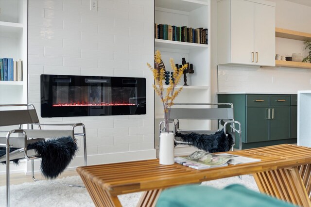 living area featuring a tile fireplace