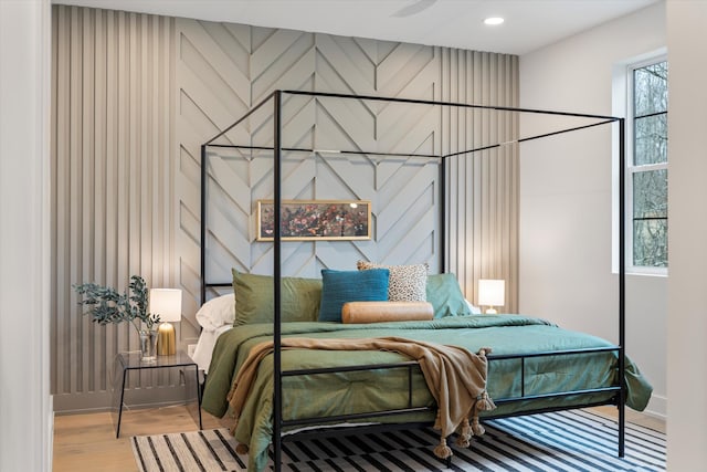 bedroom with light wood-style floors, baseboards, and recessed lighting