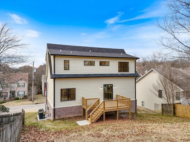 back of house with central air condition unit, a shingled roof, stairway, fence, and a wooden deck