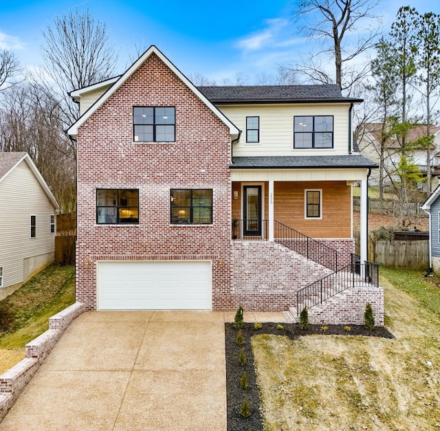 traditional-style home featuring concrete driveway, brick siding, stairway, and an attached garage