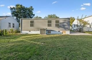 rear view of house featuring a lawn