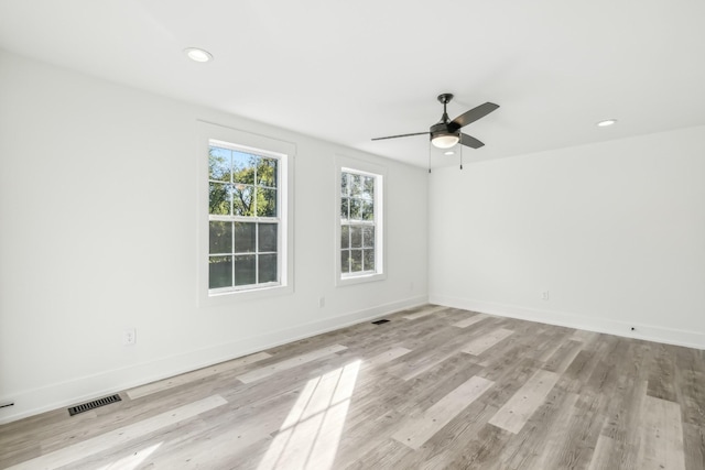 empty room featuring ceiling fan and light wood-type flooring