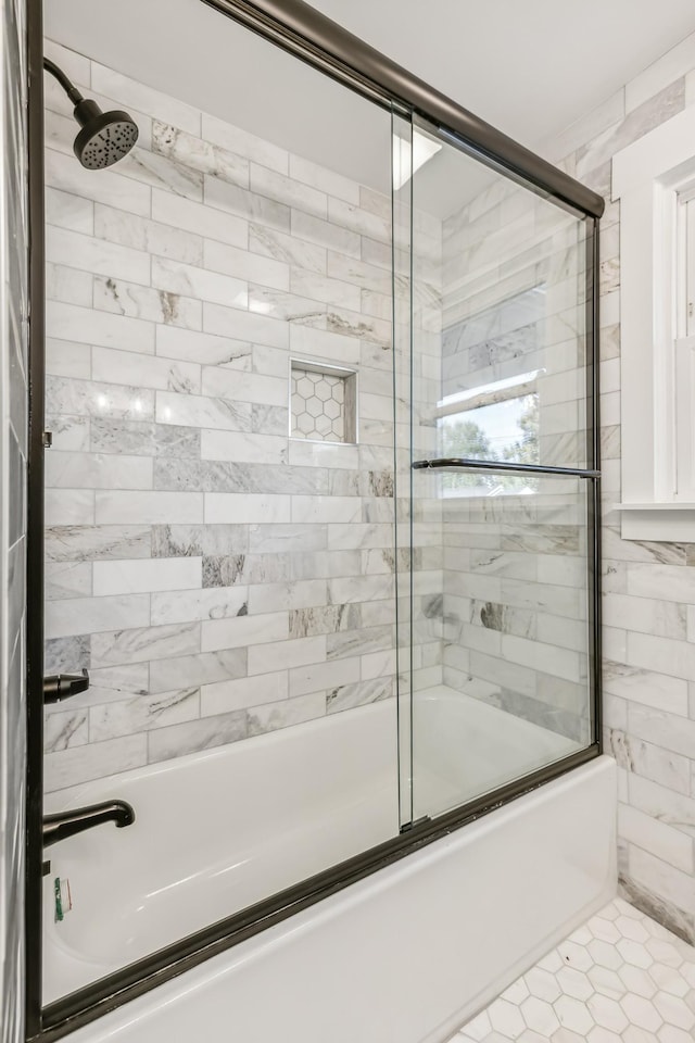 bathroom featuring tile patterned flooring and enclosed tub / shower combo