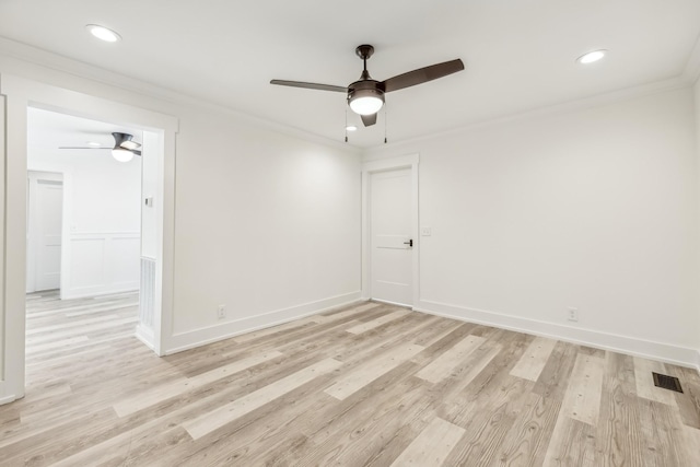 spare room featuring ceiling fan, light hardwood / wood-style floors, and crown molding