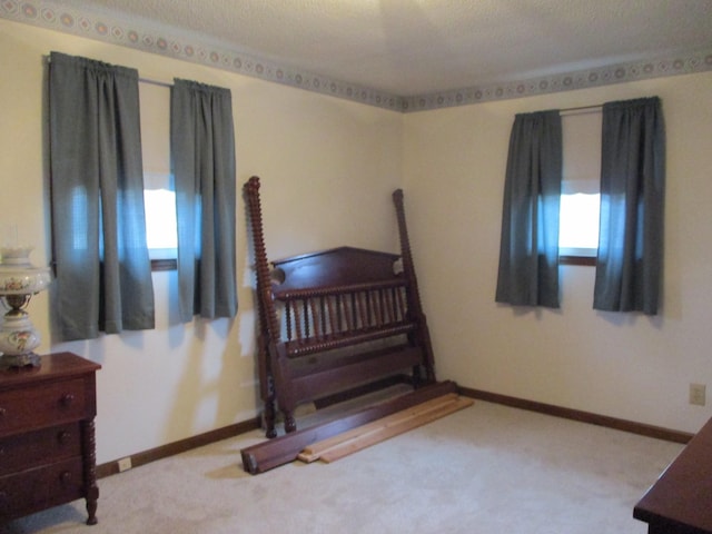 carpeted bedroom featuring a textured ceiling