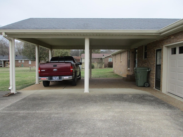 view of car parking with a yard and a carport