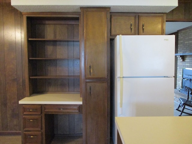 kitchen with wooden walls and white fridge