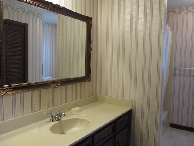 bathroom featuring vanity and shower with separate bathtub