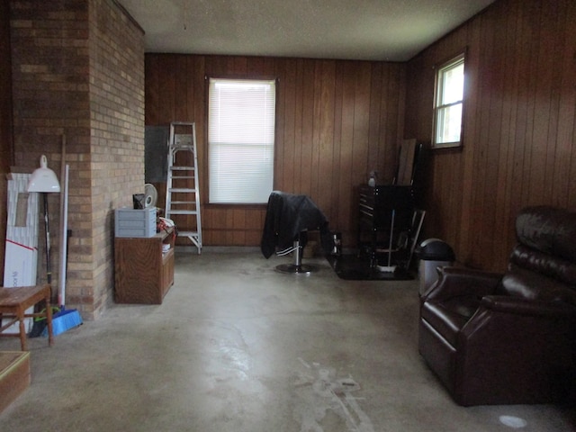 interior space with a textured ceiling and wooden walls