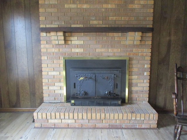 details featuring hardwood / wood-style floors and wooden walls