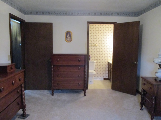 carpeted bedroom with connected bathroom