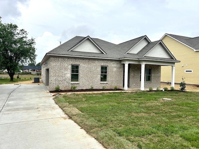 504 Gresham Ln, Murfreesboro, TN 37129 - view of front of house featuring a shingled roof, brick siding, a front lawn, and concrete driveway