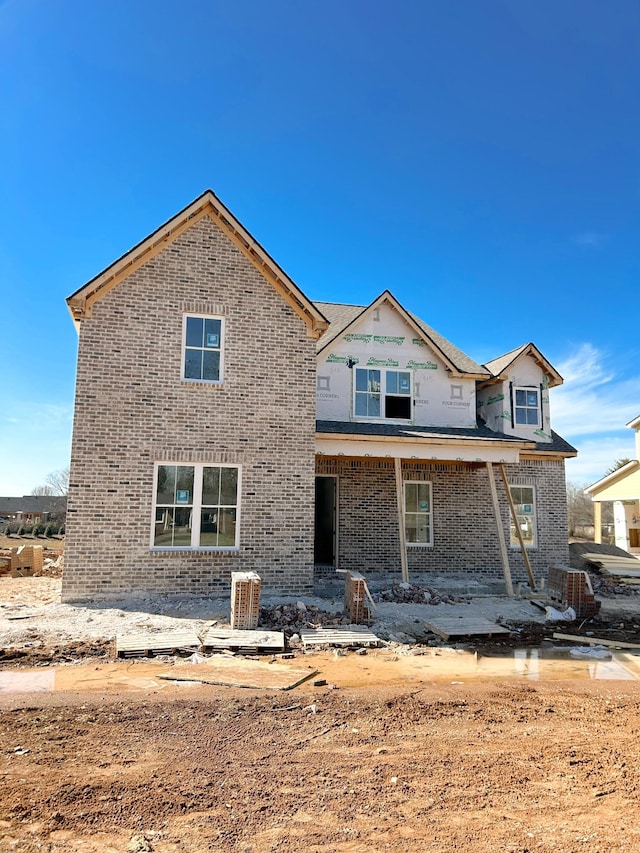 back of property with a patio and brick siding