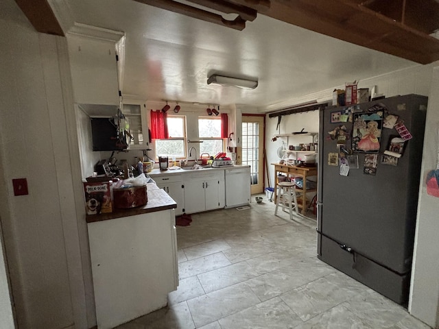 kitchen featuring white cabinetry, dishwasher, sink, and refrigerator