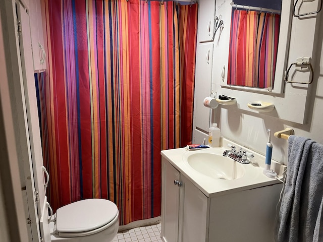 bathroom with tile patterned floors, toilet, and vanity