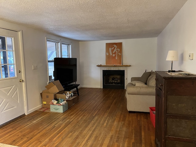 living room with dark wood-type flooring and a textured ceiling