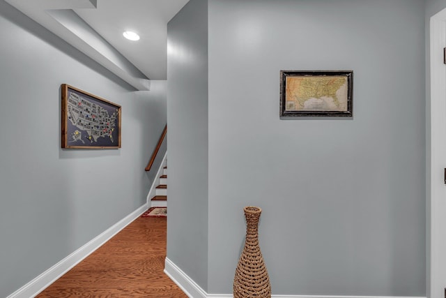 hallway with hardwood / wood-style floors