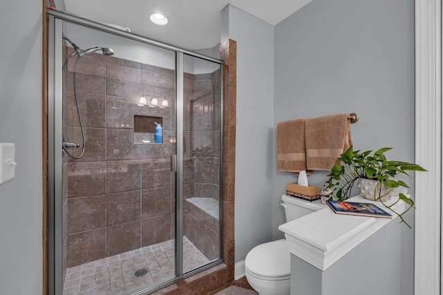 bathroom with a shower with door and toilet