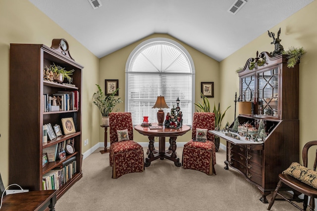 sitting room featuring light colored carpet and lofted ceiling